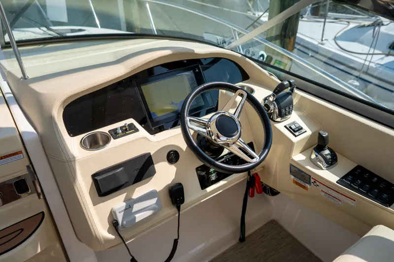 Slide: The Image of The cockpit of the 2019 Regal 33 Express features a modern steering wheel and electronic displays. - 18