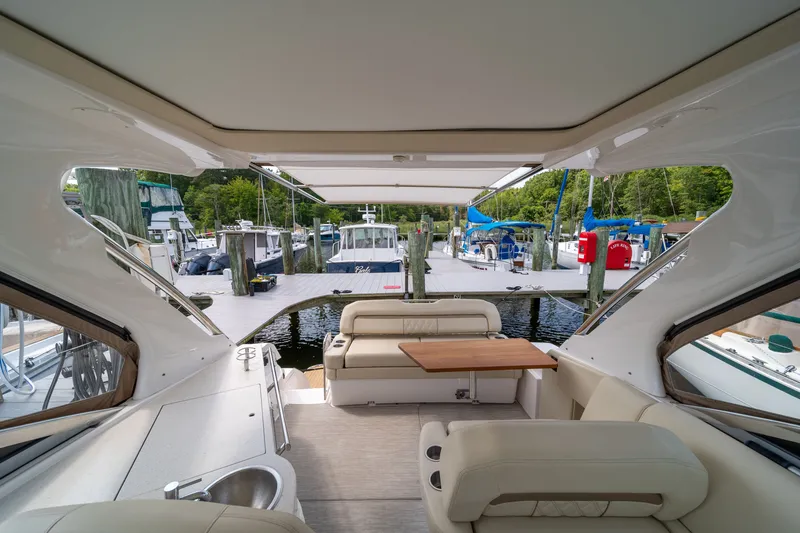 Slide: The Image of The image shows the cockpit of a 2019 Regal 33 Express docked at a marina. - 44