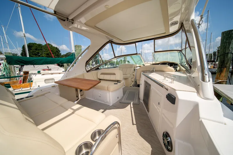 Slide: The Image of The image shows the cockpit of a 2019 Regal 33 Express with beige seating and a wooden table. - 41