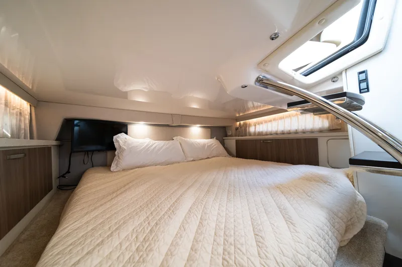 Slide: The Image of Cabin of the 2019 Regal 33 Express with a cozy bed and skylights. - 39