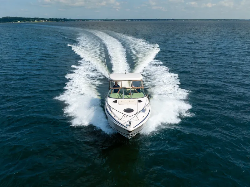 Slide: The Image of A 2019 Regal 33 Express speeding across open water. - 11