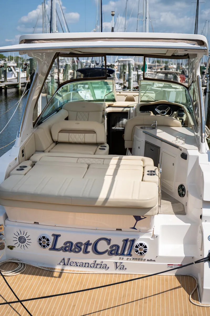 Slide: The Image of 2019 Regal 33 Express with spacious cockpit and comfortable seating, docked at a marina. - 46
