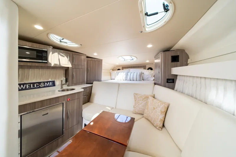 Slide: The Image of Interior of the 2019 Regal 33 Express with elegant seating area and modern kitchenette. - 33
