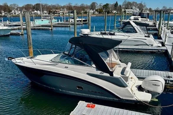 The Image of 2022 Regal 26 XO boat docked in a marina with Yamaha outboard motor. - 0