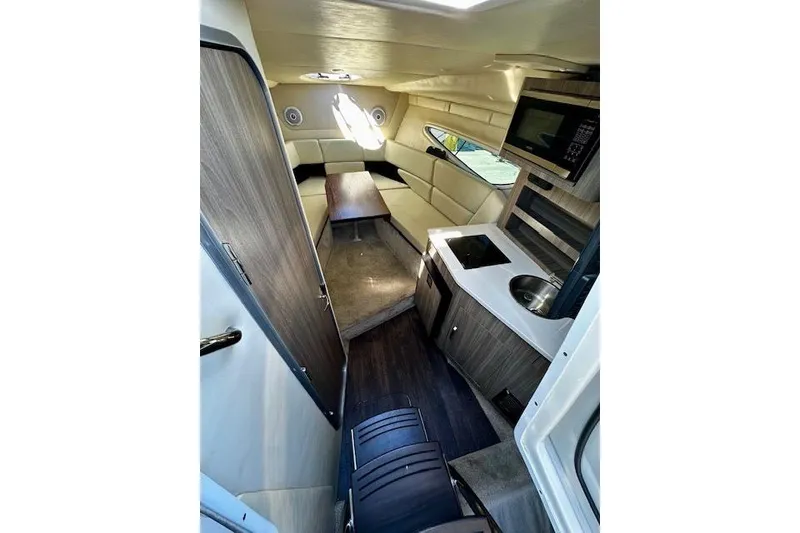 Slide: The Image of Interior of 2022 Regal 26 XO boat with kitchenette and seating area. - 10