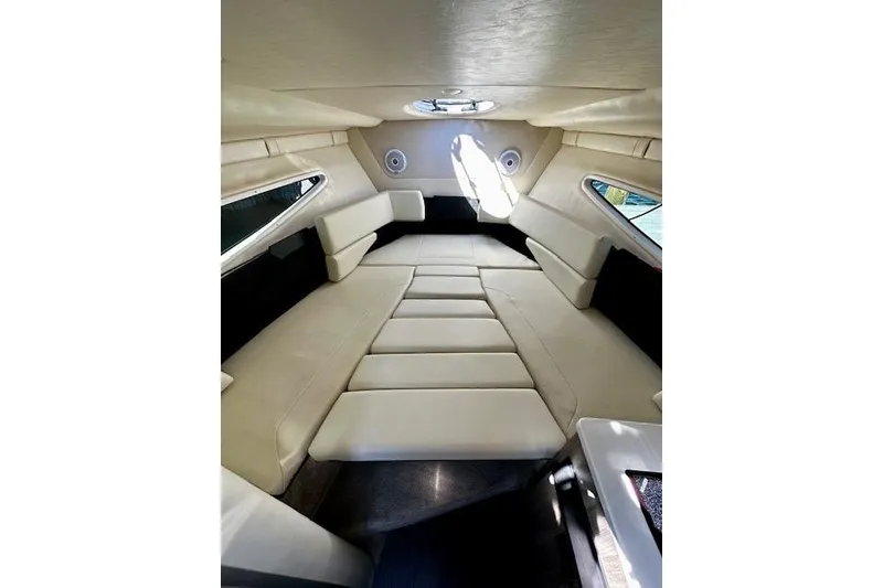 Slide: The Image of Interior cabin of 2022 Regal 26 XO boat with beige seating and circular window. - 12