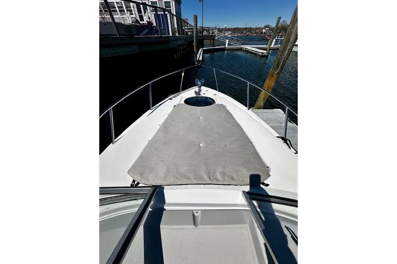 Slide: The Image of 2022 Regal 26 XO boat bow with sunpad, docked at marina. - 22