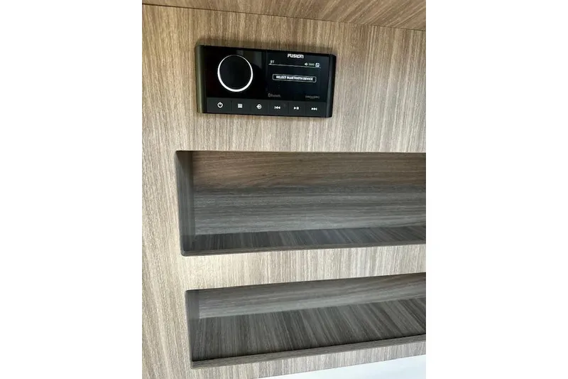 Slide: The Image of Fusion stereo system on wood panel in 2022 Regal 26 XO boat interior. - 24