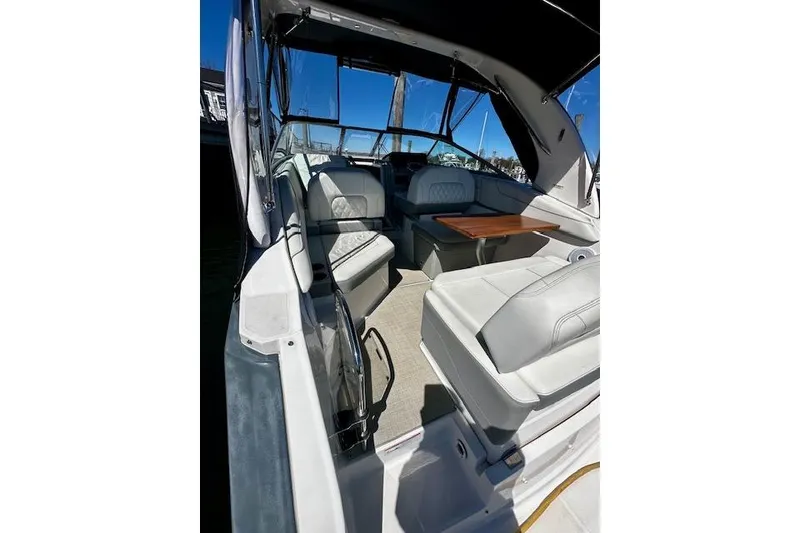 Slide: The Image of 2022 Regal 26 XO boat interior with seating and table under canopy. - 4