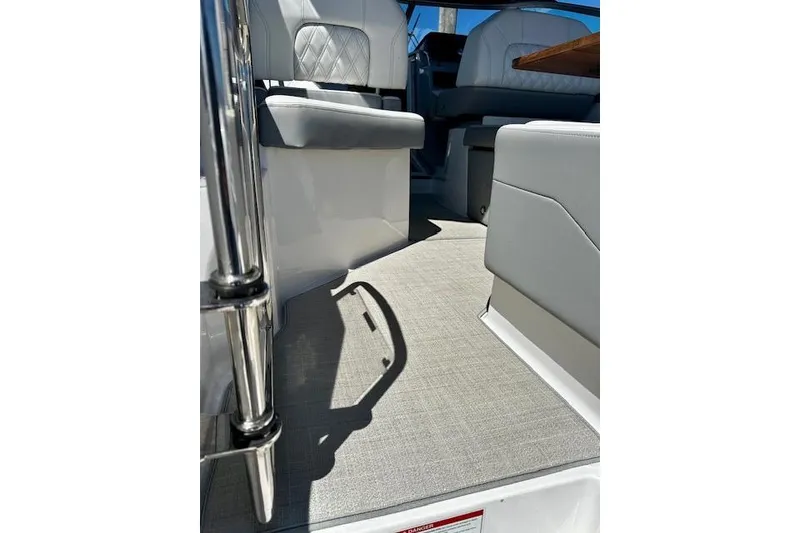 Slide: The Image of Interior view of 2022 Regal 26 XO boat with cushioned seating and sleek design. - 5