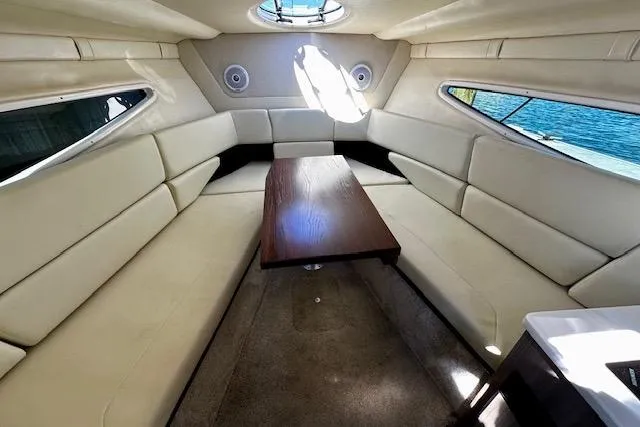 Slide: The Image of Luxurious interior of 2022 Regal 26 XO boat with plush seating and wooden table. - 6