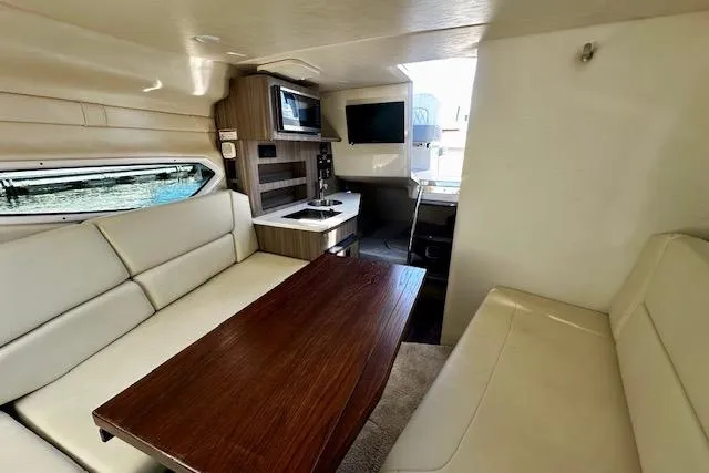 Slide: The Image of Interior of 2022 Regal 26 XO boat with seating, table, and kitchenette. - 7