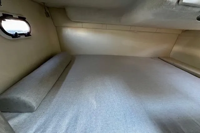 Slide: The Image of 2022 Regal 26 XO cabin interior with bed and small window. - 9