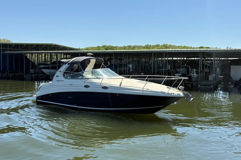 The Image of 2005 Sea Ray Sundancer 280 boat docked on calm water under clear sky. - 0