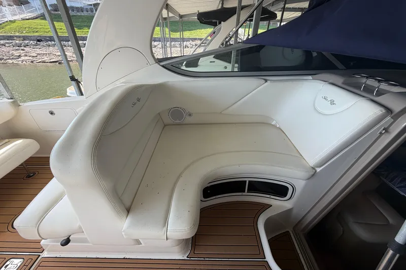 Slide: The Image of 2005 Sea Ray Sundancer 280 interior with white seating and wood flooring. - 10