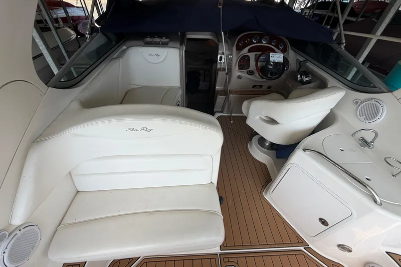 Slide: The Image of 2005 Sea Ray Sundancer 280 interior with white seating and wooden flooring. - 11