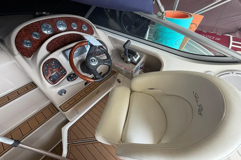 Slide: The Image of 2005 Sea Ray Sundancer 280 helm with steering wheel and control panel. - 13