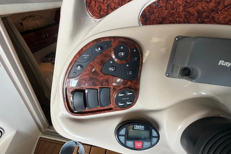 Slide: The Image of Control panel of a 2005 Sea Ray Sundancer 280 boat with various switches and buttons. - 16