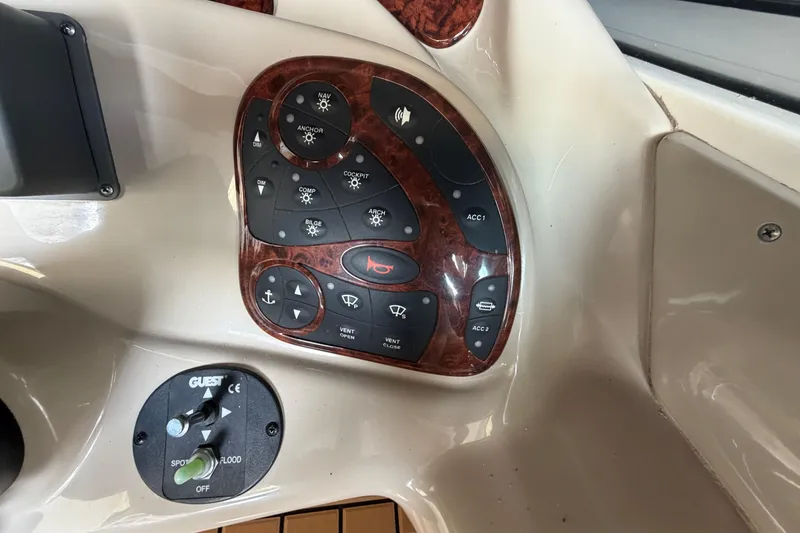 Slide: The Image of Control panel of a 2005 Sea Ray Sundancer 280 boat with various switches. - 17