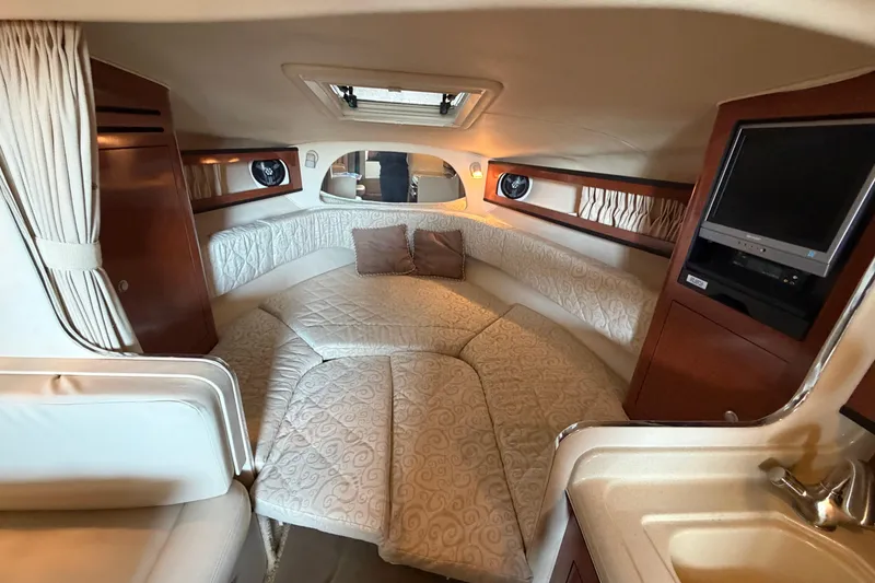 Slide: The Image of Interior of 2005 Sea Ray Sundancer 280, featuring cozy seating and entertainment area. - 19