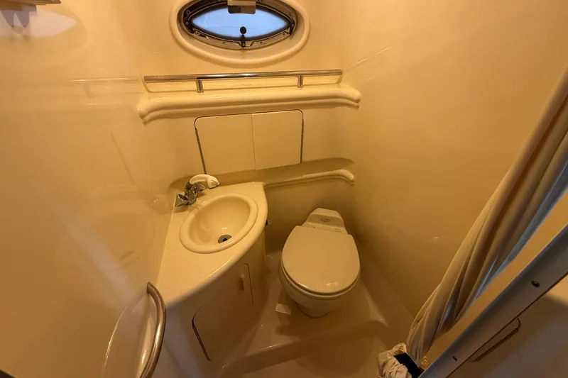 Slide: The Image of Compact bathroom in a 2005 Sea Ray Sundancer 280 yacht, featuring a sink and toilet. - 24