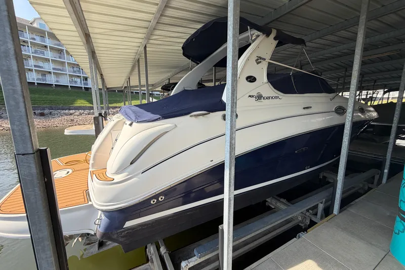 Slide: The Image of 2005 Sea Ray Sundancer 280 docked under a covered marina. - 4