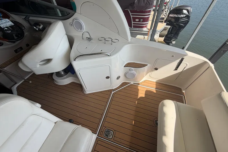 Slide: The Image of 2005 Sea Ray Sundancer 280 cockpit with seating, helm, and teak flooring. - 7