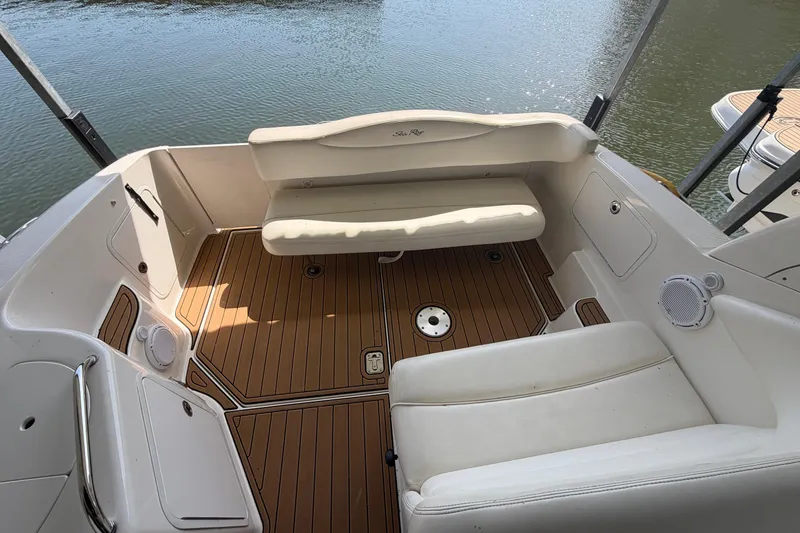 Slide: The Image of 2005 Sea Ray Sundancer 280 boat interior with cushioned seating and teak flooring. - 8