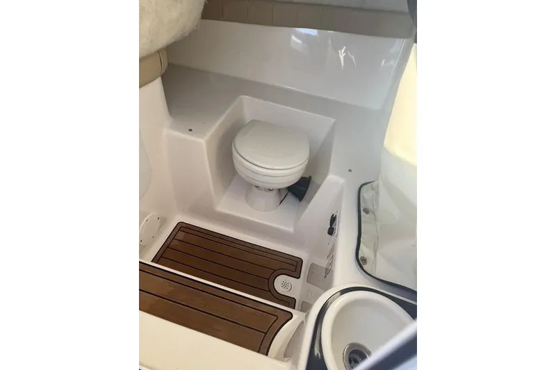 Slide: The Image of 2015 Sea Fox 249 Avenger boat interior with toilet and wooden flooring. - 12