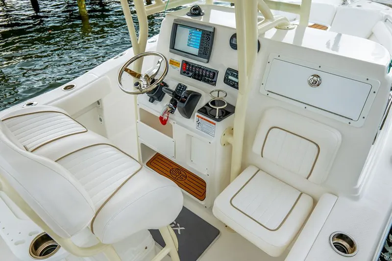 Slide: The Image of Manufacturer Provided Image: 2015 Sea Fox 249 Avenger boat cockpit with steering wheel and navigation controls. - 15