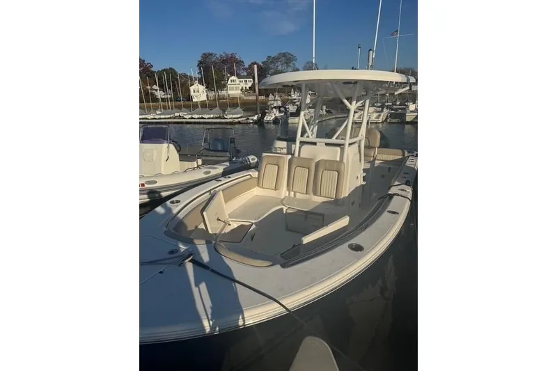 Slide: The Image of 2015 Sea Fox 249 Avenger boat docked in a marina under clear skies. - 2
