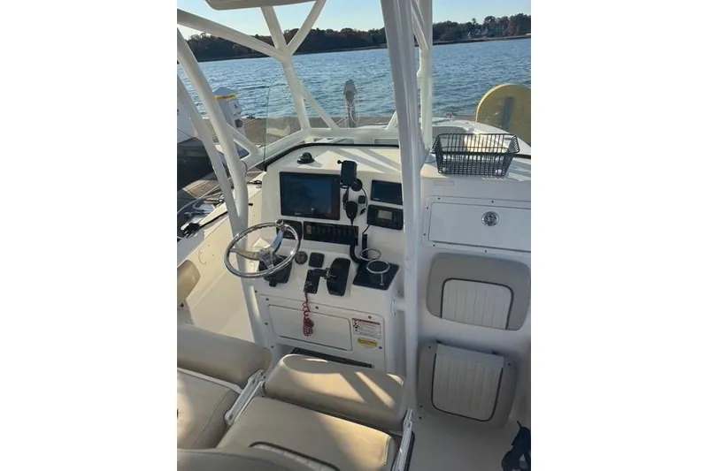 Slide: The Image of 2015 Sea Fox 249 Avenger boat cockpit with steering wheel and control panel. - 3