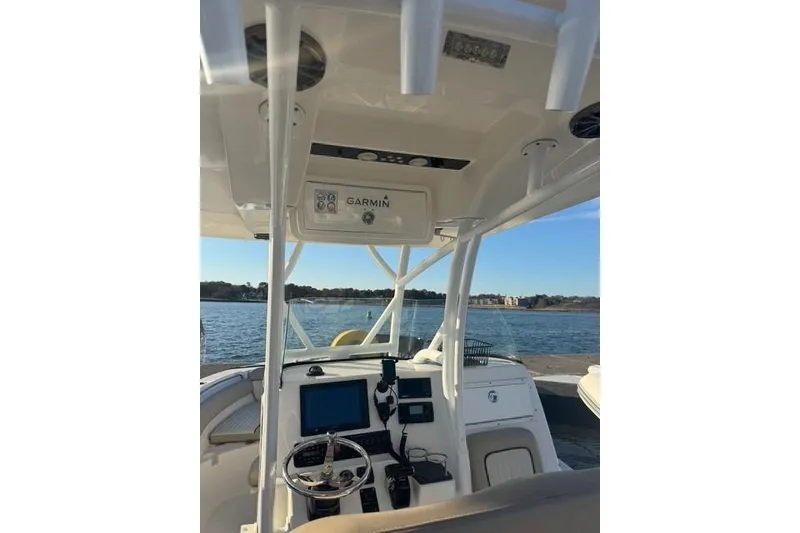 Slide: The Image of 2015 Sea Fox 249 Avenger boat cockpit with Garmin navigation system on a sunny day. - 4