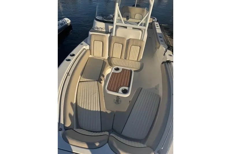 Slide: The Image of 2015 Sea Fox 249 Avenger boat interior with cushioned seating and wooden table. - 9