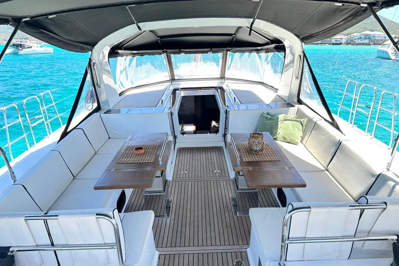 Slide: The Image of Luxurious 2019 Beneteau Oceanis Yacht 62 cockpit with elegant seating and tables. - 14