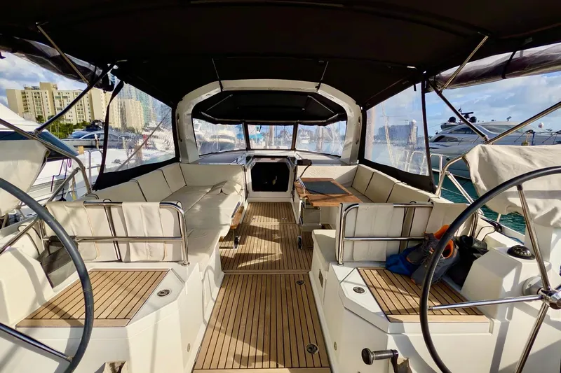 Slide: The Image of Luxurious 2019 Beneteau Oceanis Yacht 62 cockpit with elegant seating and steering wheel. - 15