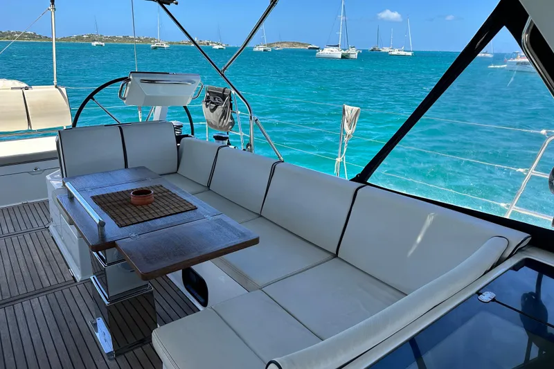 Slide: The Image of Luxurious seating area on 2019 Beneteau Oceanis Yacht 62 with ocean view. - 17