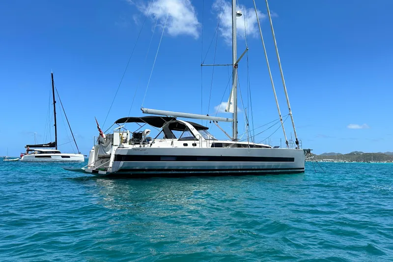 Slide: The Image of 2019 Beneteau Oceanis Yacht 62 sailing on clear blue waters under a bright sky. - 2