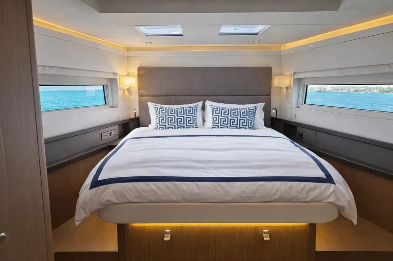 Slide: The Image of Luxurious bedroom interior of 2019 Beneteau Oceanis Yacht 62 with ocean view windows. - 25