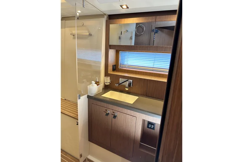 Slide: The Image of Luxurious bathroom interior of 2019 Beneteau Oceanis Yacht 62 with wooden cabinetry and modern fixtures. - 28