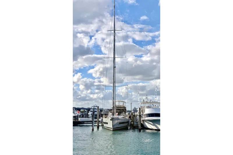 Slide: The Image of 2019 Beneteau Oceanis Yacht 62 docked at marina under cloudy sky. - 31