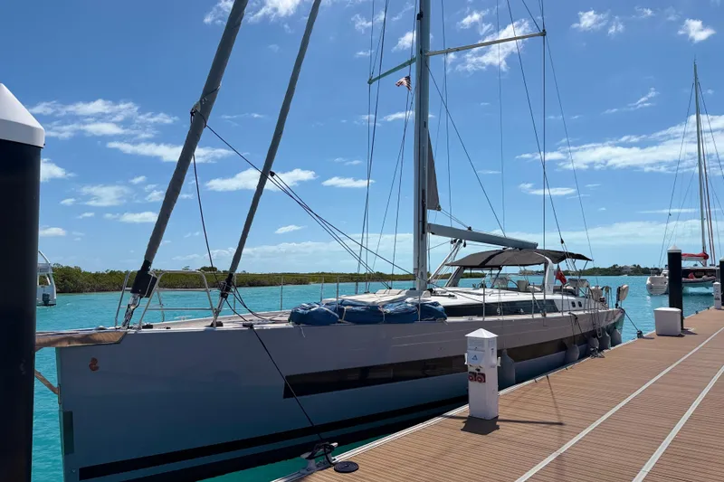 Slide: The Image of 2019 Beneteau Oceanis Yacht 62 docked under clear blue skies. - 33