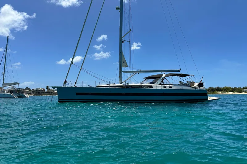 Slide: The Image of 2019 Beneteau Oceanis Yacht 62 sailing on clear blue waters under a sunny sky. - 9
