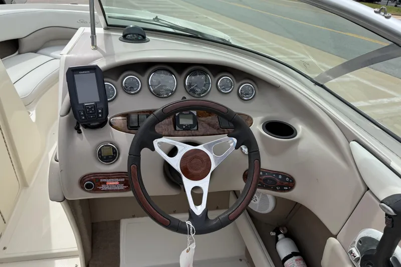 Slide: The Image of Steering console of a 2003 Sea Ray 240 Bow Rider with gauges and Garmin device. - 14
