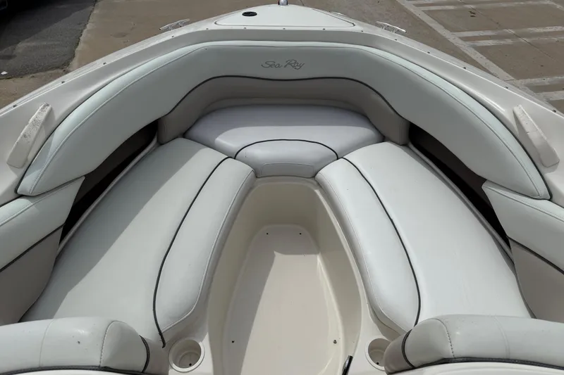 Slide: The Image of 2003 Sea Ray 240 Bow Rider boat interior with white cushioned seating. - 15