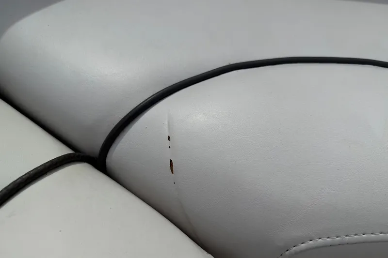 Slide: The Image of Close-up of a 2003 Sea Ray 240 Bow Rider seat with a small tear. - 16