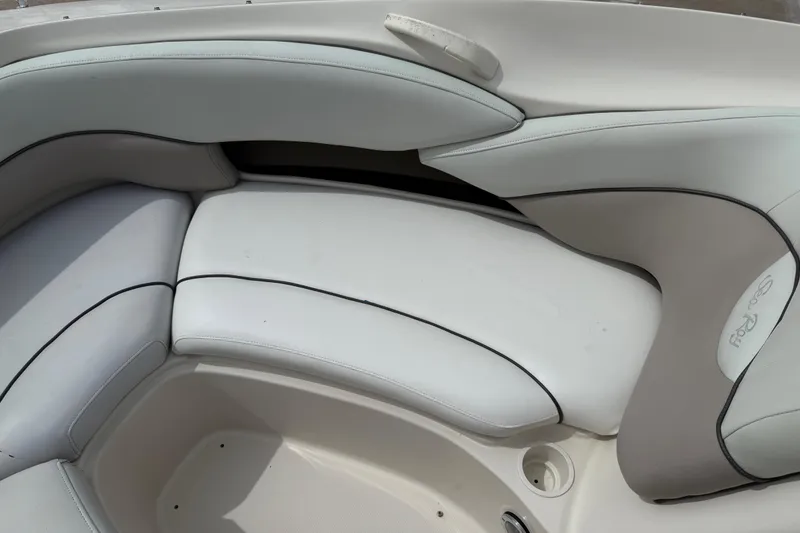 Slide: The Image of Interior seating of a 2003 Sea Ray 240 Bow Rider boat, featuring white upholstery. - 18