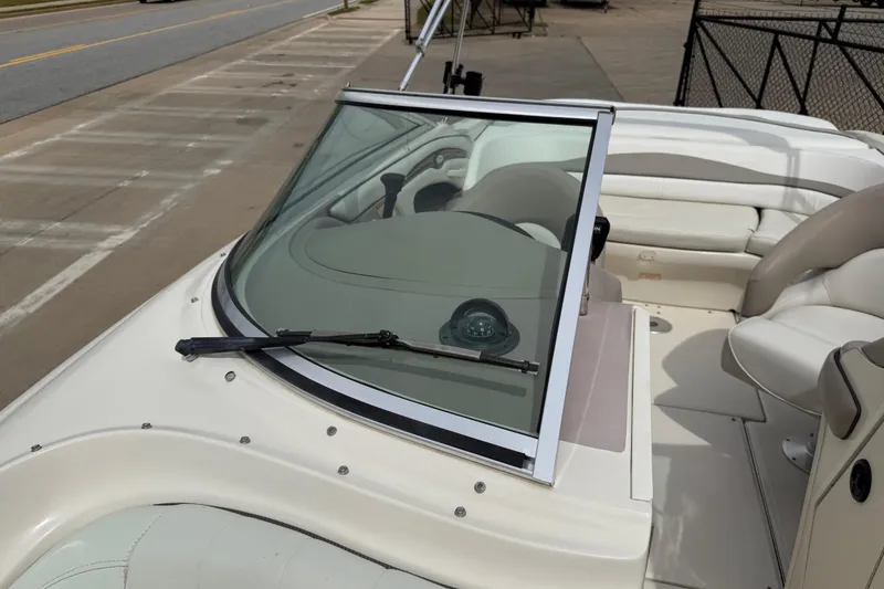 Slide: The Image of 2003 Sea Ray 240 Bow Rider boat interior with windshield and seating area. - 19