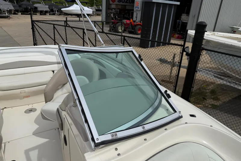 Slide: The Image of 2003 Sea Ray 240 Bow Rider boat with windshield, parked in a marina. - 20