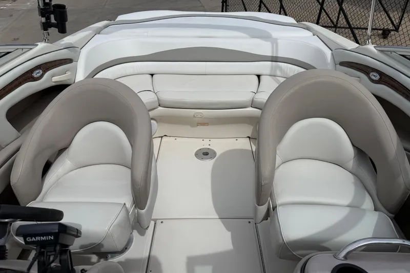 Slide: The Image of 2003 Sea Ray 240 Bow Rider interior with white seating and Garmin equipment. - 22